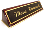 Laser engraved name plates have a cherry wood base.