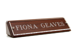 Wood and plastic nameplates fit well on any desk.